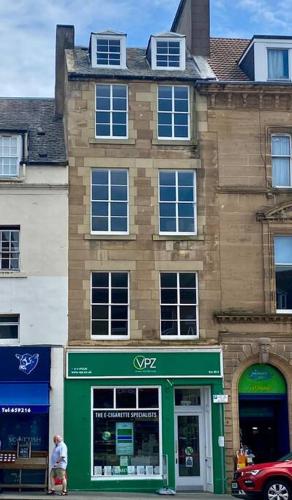 a man standing in front of a building at Number 6 Crossgate in Fife