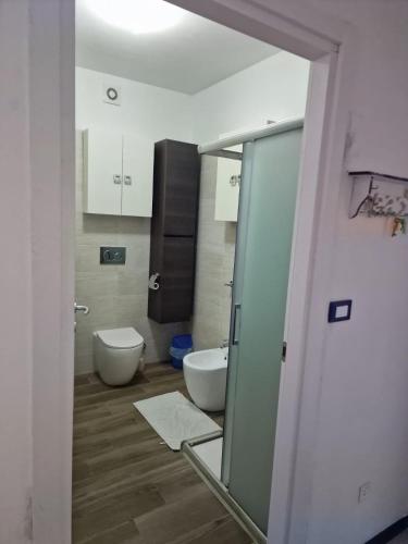 a bathroom with a toilet and a sink and a mirror at Laguna Blu in Ventimiglia