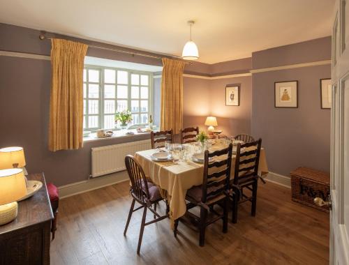 a dining room with a table and chairs and a window at Lightfoot Cottage in Bishop Auckland
