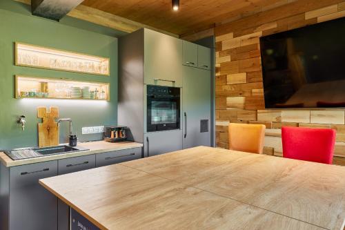 a kitchen with a wooden counter top in a room at Horský dům Urlas in Pec pod Sněžkou