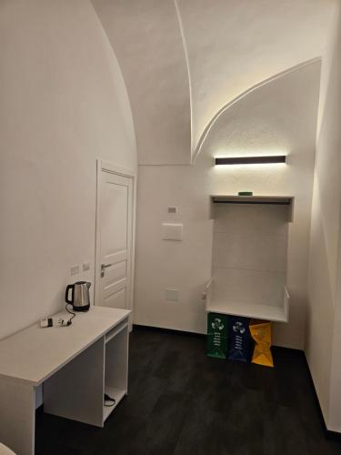 a room with a counter and a sink in it at La Dama del Castello in Bosa
