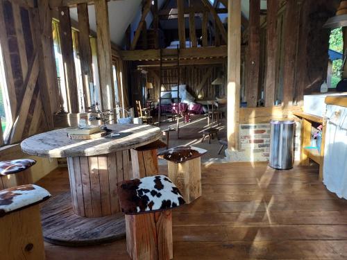 Cette grande chambre comprend un comptoir et des tabourets. dans l'établissement Le Cocon, Gîte du Manoir de La Porte, à Les Authieux-sur-Calonne