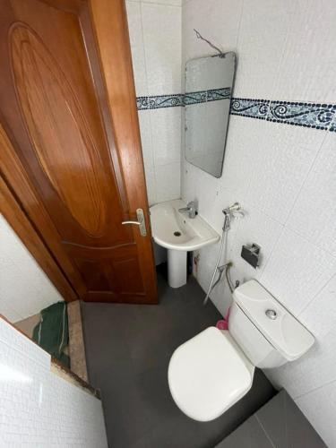 a small bathroom with a toilet and a sink at Studio meublé sur la vdn liberté 6 extension in Dakar