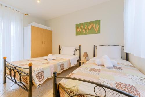 a bedroom with two beds in a room at The Blue House in Leptokarya
