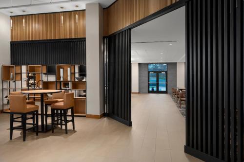 a dining room and library with a table and chairs at Hyatt Place Denver Cherry Creek in Denver