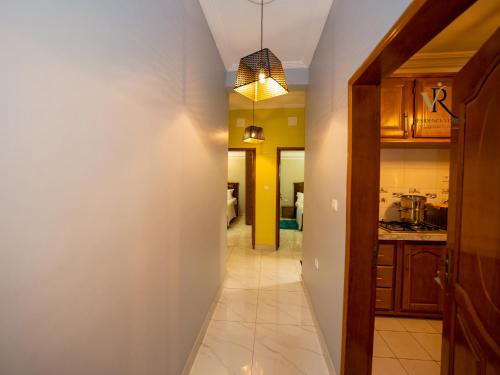 a hallway leading into a kitchen with a hallway at Résidence Vinelly in Douala