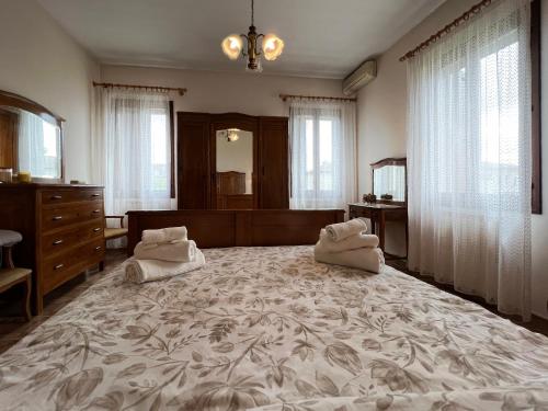 una camera da letto con un grande letto con due cuscini sopra di Ca'Mia - Rooms a Porto Tolle