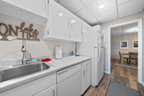 a kitchen with white cabinets and a sink at New Lake View Retreat Pool 4min to Beach in Lake Geneva