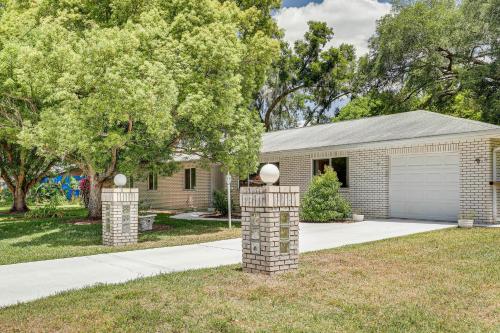 a house with two stone pillars in the front yard at Valrico Vacation Rental about 10 Mi to Dinosaur World! in Valrico