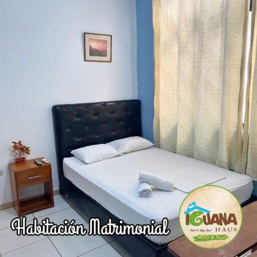 a small bed in a room with a window at IGUANA HAUS IQUITOS in Iquitos