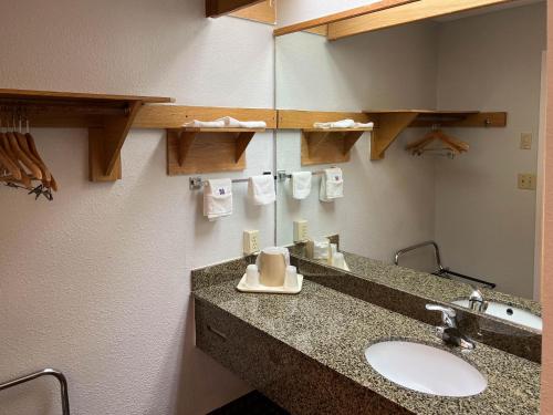a bathroom with a sink and a mirror at Motel 6 Portland OR Southeast in Portland