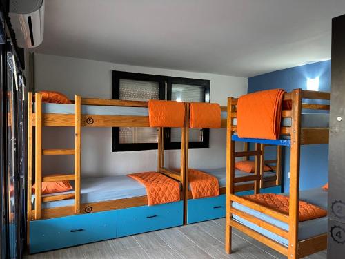 a bunk bed room with three bunk beds at Blue Orange Lake Hostel in Ohrid