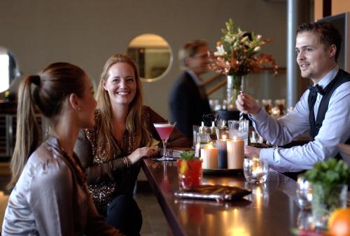 a group of people sitting around a table in a restaurant at Strömstad Spa & Resort in Strömstad