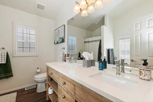 a white bathroom with a sink and a toilet at Fitzy's Fir Lodge - Fun For the Whole Family, Dogs Welcome, Jacuzzi Tub in Sugarloaf