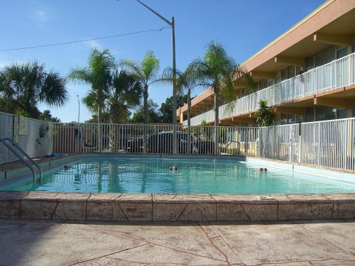 a swimming pool in front of a building at America's Best Inn & Suites-Lakeland in Lakeland