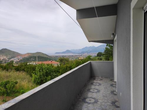 a balcony with a view of the mountains at Zelena Maslina in Bar