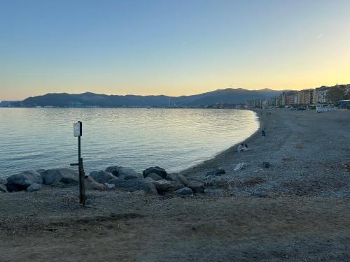 a group of rocks on the shore of a beach at Hotel San Marco in Savona