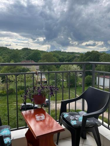 a balcony with a chair and a table with a view at Laki in Nikšić