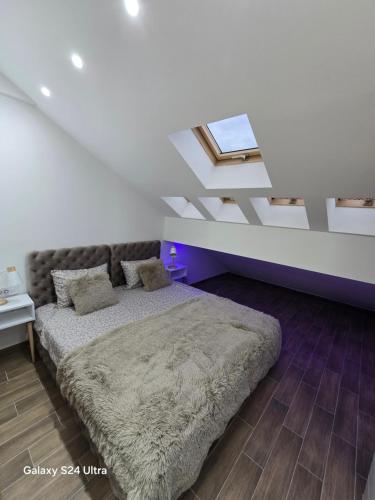 a bedroom with a bed and a ceiling with a window at IDILA SPA in Novi Beograd
