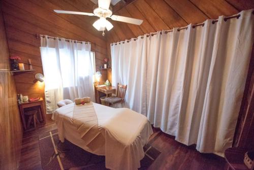 a room with a table and a ceiling fan at St. George's Caye Resort in Belize City