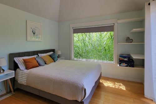 a bedroom with a bed and a large window at Relaxing in Renton in Renton