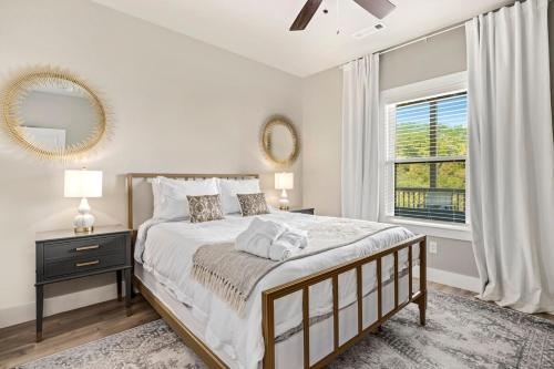 a bedroom with a large bed and a window at The Dogwood-Hot Tub-Lake Front Access in Springdale