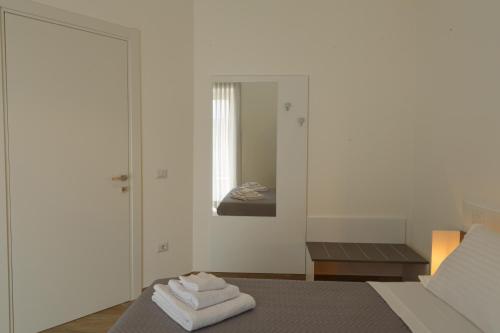 a bedroom with a bed with two folded towels on it at Fresia B&B in Tuscania