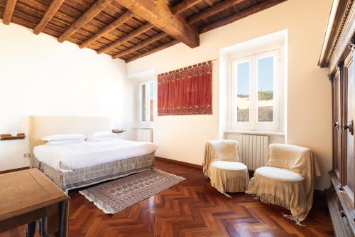 1 Schlafzimmer mit 2 Betten und 2 Stühlen in der Unterkunft Trevi Comfortable Apartment with Terrace | Romeloft in Rom
