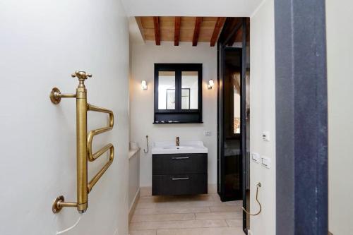 a bathroom with a white sink and a mirror at Pantheon Stylish Attic in Rome