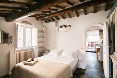 a bedroom with a large white bed in a room at Scala Lovely Terrace Apartment in Rome