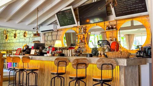 a bar in a restaurant with stools at a counter at Alaçatı Wellness Garden in Alacati
