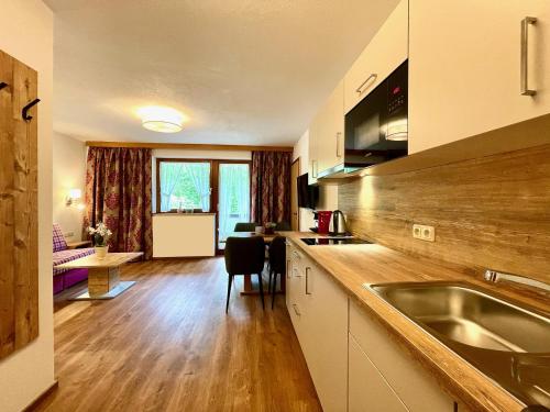 a kitchen with a sink and a counter top at Apart Fortuna in See