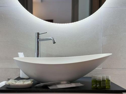 a white sink in a bathroom with a mirror at Como - Magic Garden House - Lake View in Como