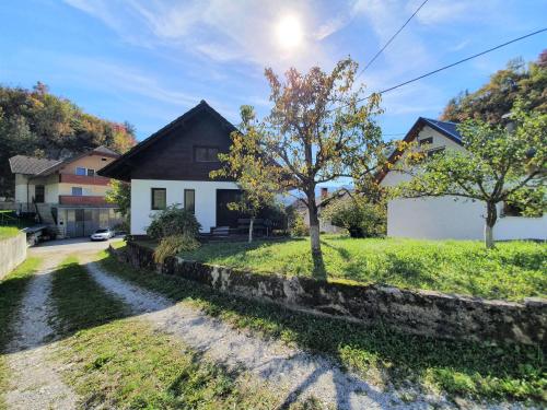 a house with a tree in the yard at Bella Bela Apartments 18A in Bled