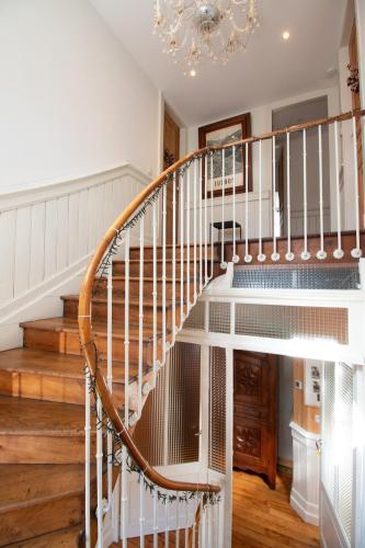a spiral staircase in a home with a chandelier at LE 41 AVENUE FOCH in Luchon