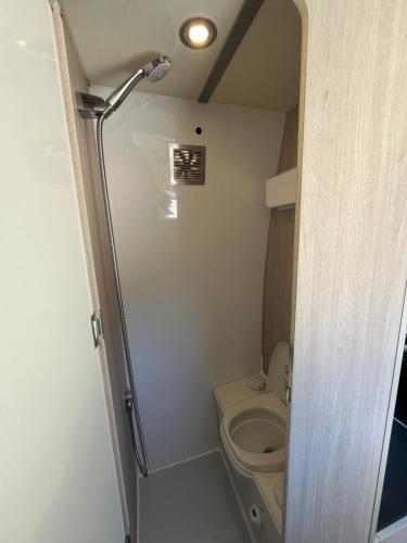 a small bathroom with a toilet and a shower at Beautiful Campervan (Mallorca) in San Francesch