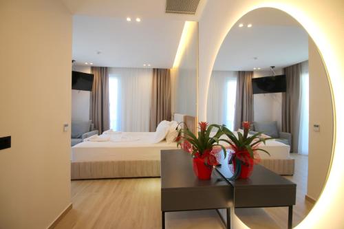 a bedroom with a bed and a table with a mirror at Onix H in Ksamil