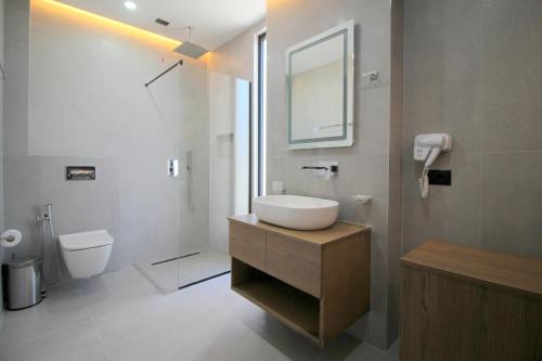 a bathroom with a sink and a toilet at Onix H in Ksamil