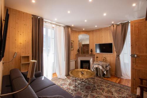 a living room with a couch and a table at LE 41 AVENUE FOCH in Luchon
