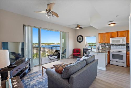 a living room with a couch and a kitchen at Oceanfront Luxury Condo! Mins to beach! Rum Bar Next Door! in St. Petersburg