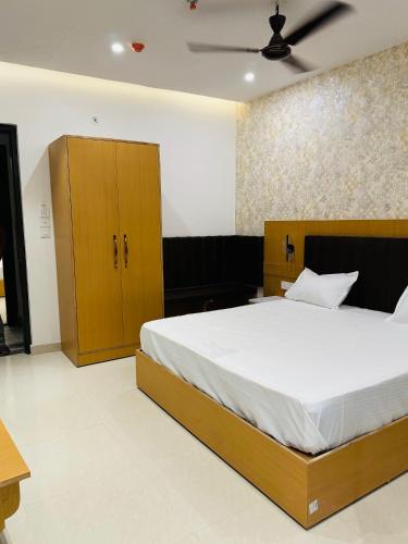 a bedroom with a large bed and wooden cabinets at Royal Palace Lucknow in Lucknow