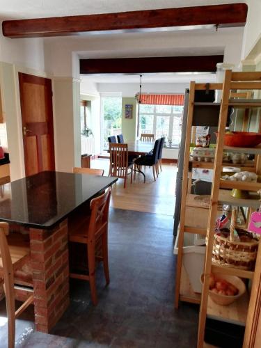 una cucina e una sala da pranzo con tavolo e sedie di Orchard Park a Bromley