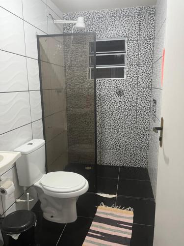 a bathroom with a toilet and a shower at Casa do Monte in Guarulhos