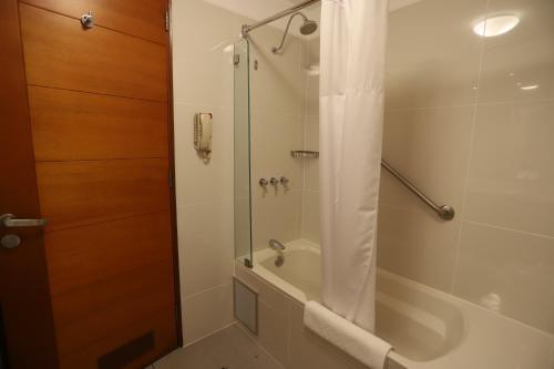 a bathroom with a shower with a tub and a sink at Casa Andina Select Miraflores in Lima