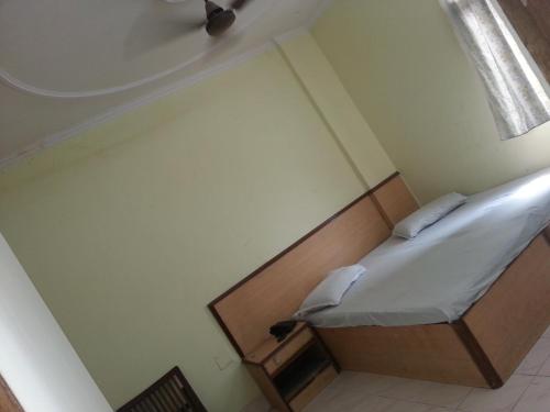 a small bed in a room with a window at Hotel Prince Palace (The Green) in New Delhi