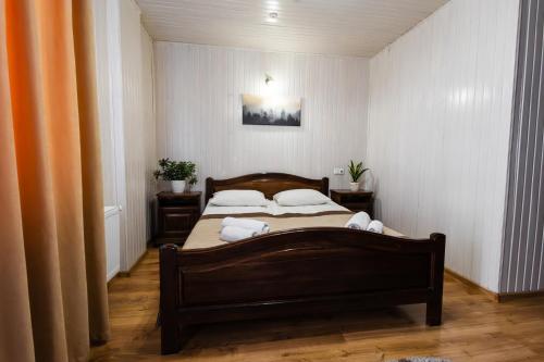 a bedroom with a bed with two pillows on it at Villa Anet in Bukovel