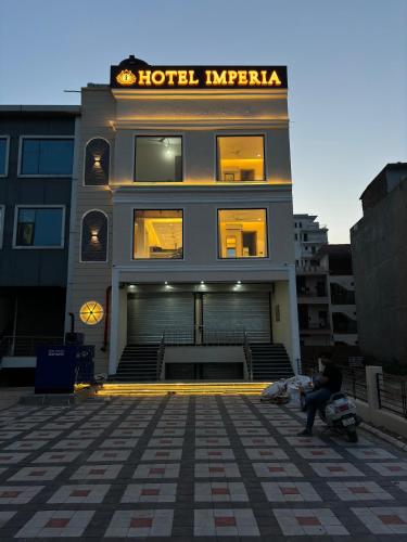 a person sitting in front of a hotel imperial at Hotel imperia in Kharar