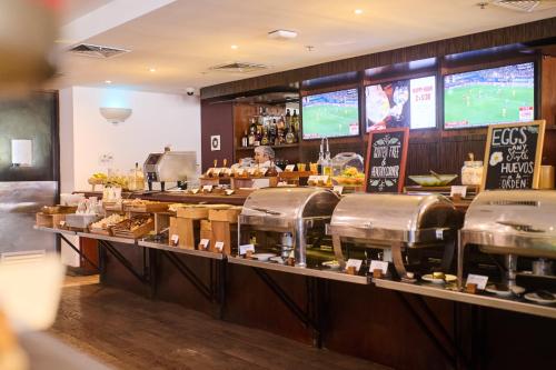 a man behind the counter of a fast food restaurant at Casa Andina Select Miraflores in Lima