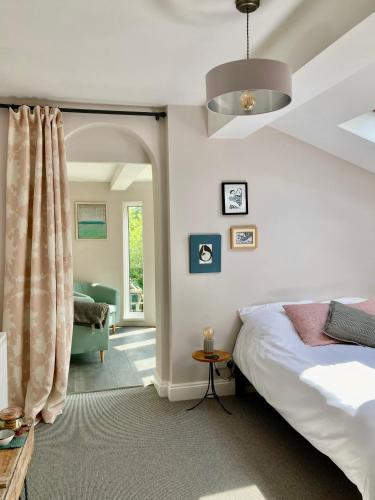a bedroom with a bed and a living room at The Old Stables, The River Severn, Shrewsbury in Shrewsbury