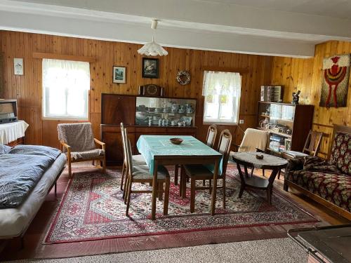 a living room with a table and a couch at Soukromí pod skalami - Dolní Adršpach in Adršpach